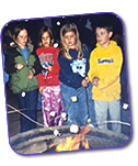 Campers making friends and roasting marcshmallows at Camp Crescendo Music Camp